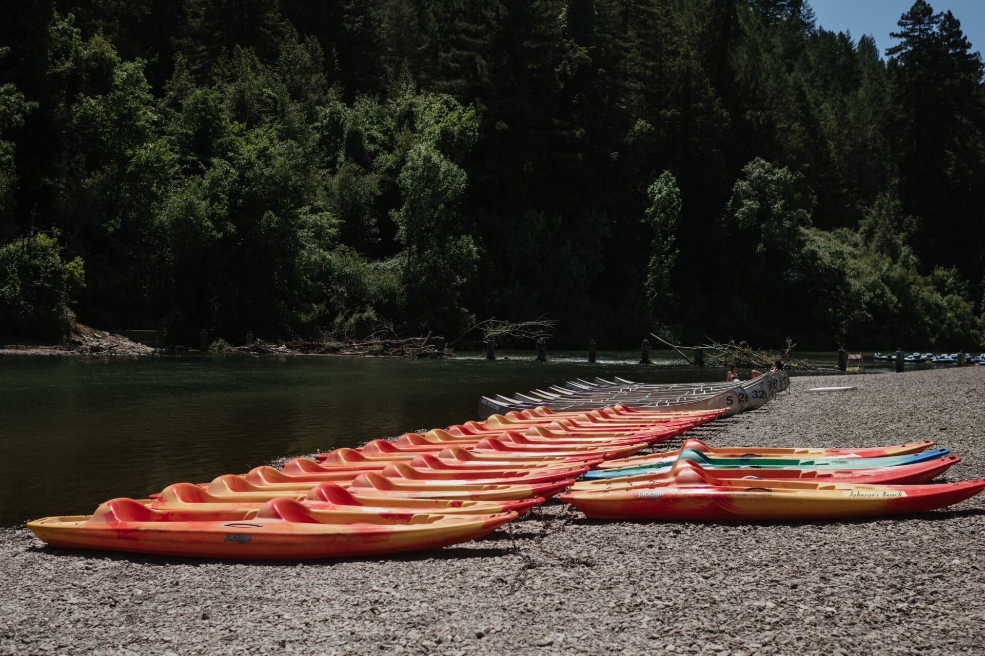 Kayaks along river shore